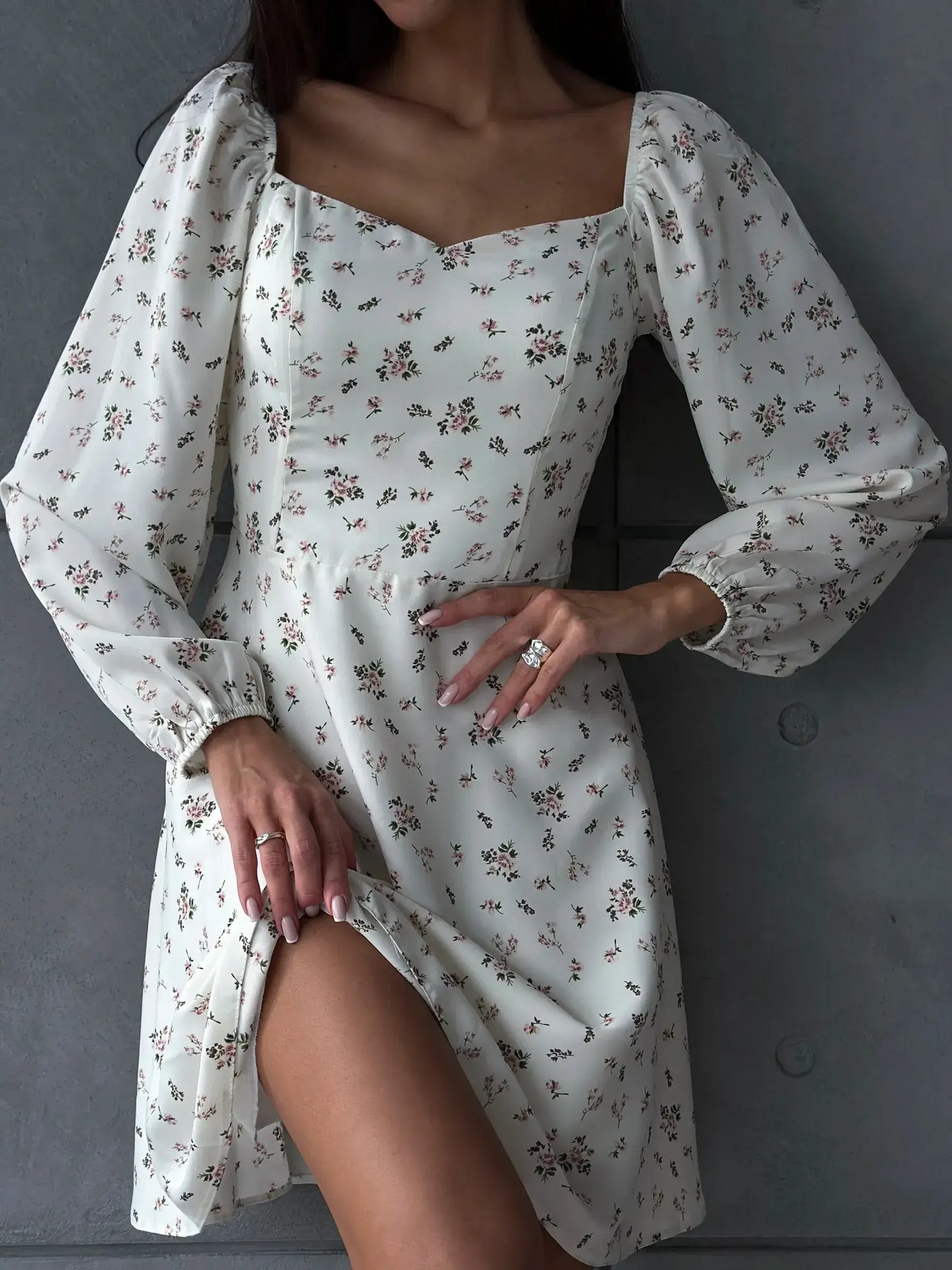 Elegant white summer dress with floral print, featuring long puff sleeves and a sweetheart neckline.
