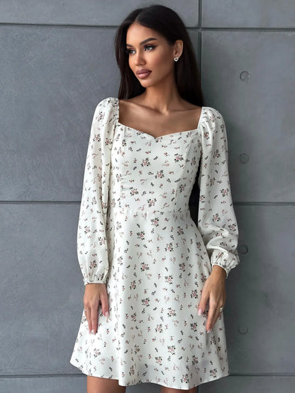 Chic floral dress with puffed sleeves and square neckline, perfect for summer celebrations and casual outings.