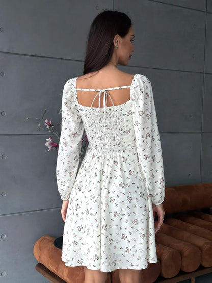 Back view of the Blossom Grace white dress featuring floral print and puff sleeves, perfect for summer celebrations.