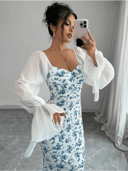 Model wearing the Bluebelle Maxi Dress, showcasing vintage florals and sheer sleeves in an elegant pose.