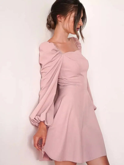 Blush Aura mini dress with puff sleeves and square neckline, perfect for weddings and formal occasions.