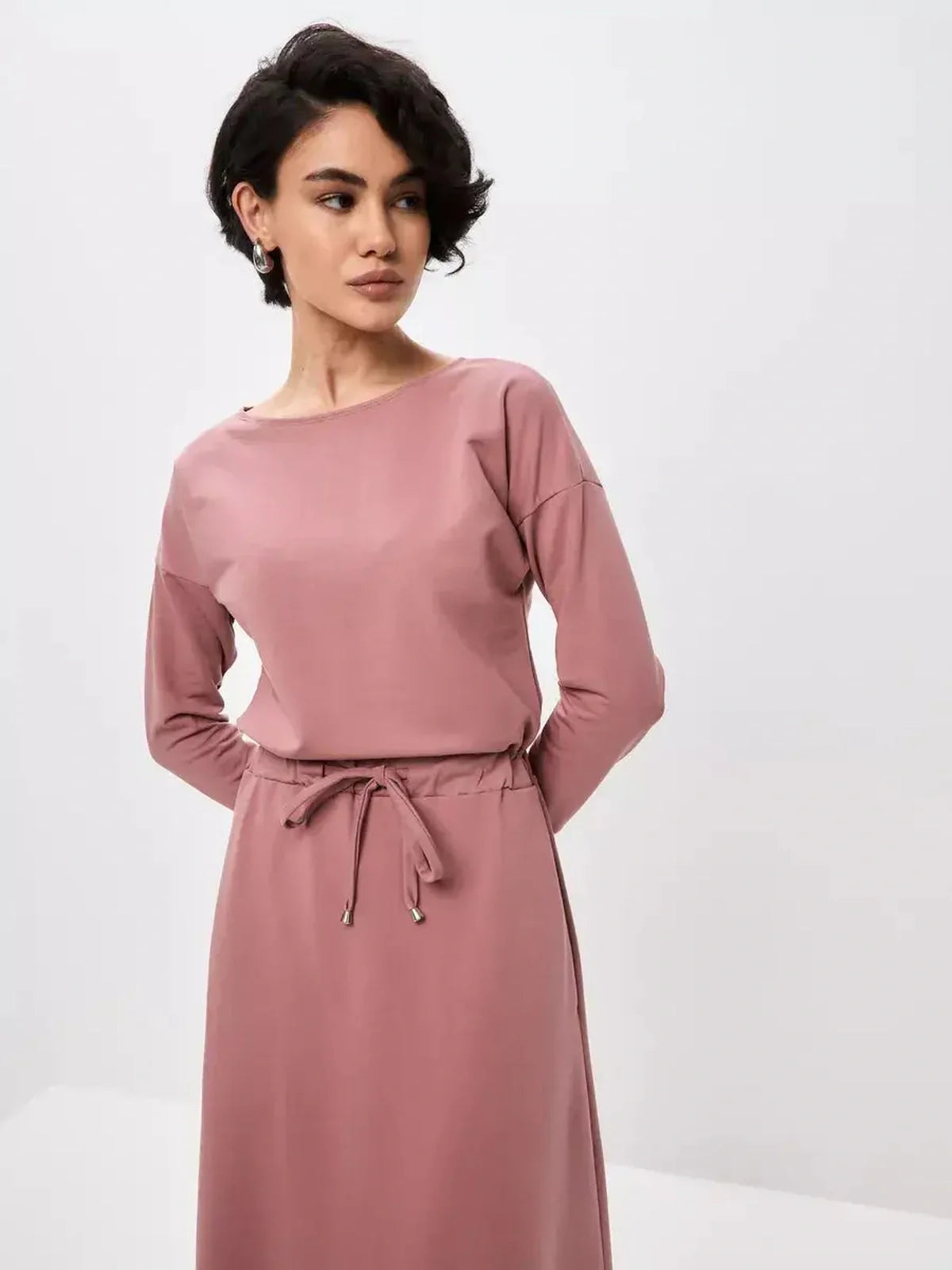 Blush Lounge Maxi Dress in dusty pink, featuring long sleeves and adjustable drawstring waist for stylish comfort.