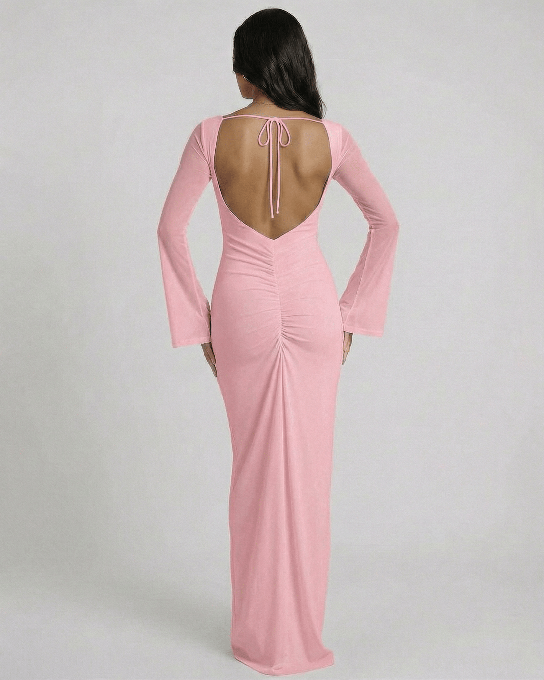 Back view of Lauven Blush Maxi Dress with open back and long sleeves in soft pink.