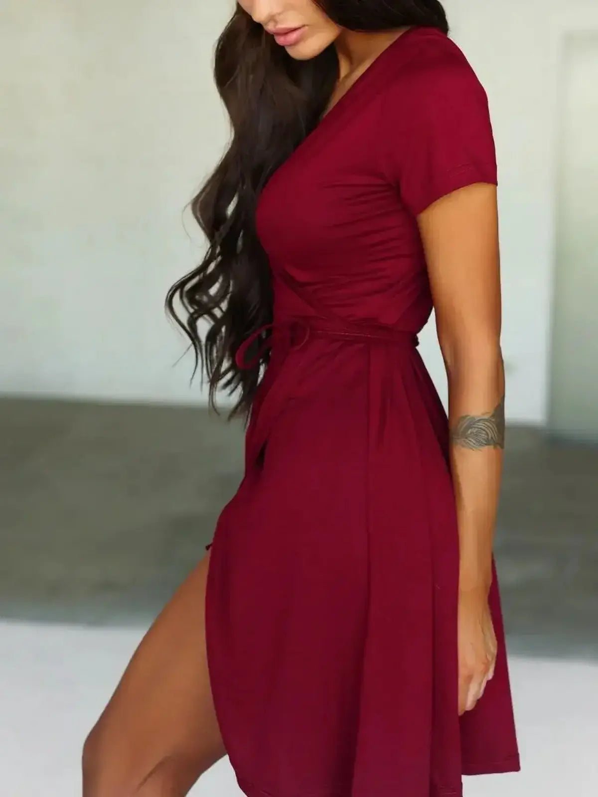 Chic burgundy wrap dress with short sleeves, perfect for summer or semi-formal events.
