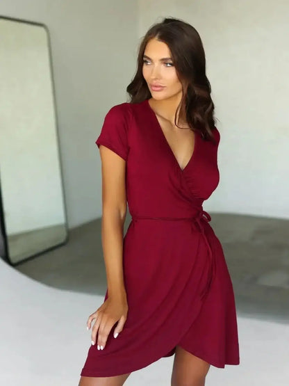 Chic burgundy wrap mini dress with short sleeves, perfect for summer and special occasions.