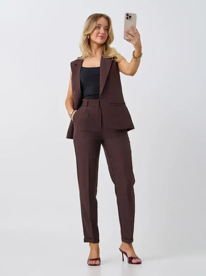 Model showcasing Lauven Cacao Suit Set with sleeveless chocolate vest and high-waist pants.