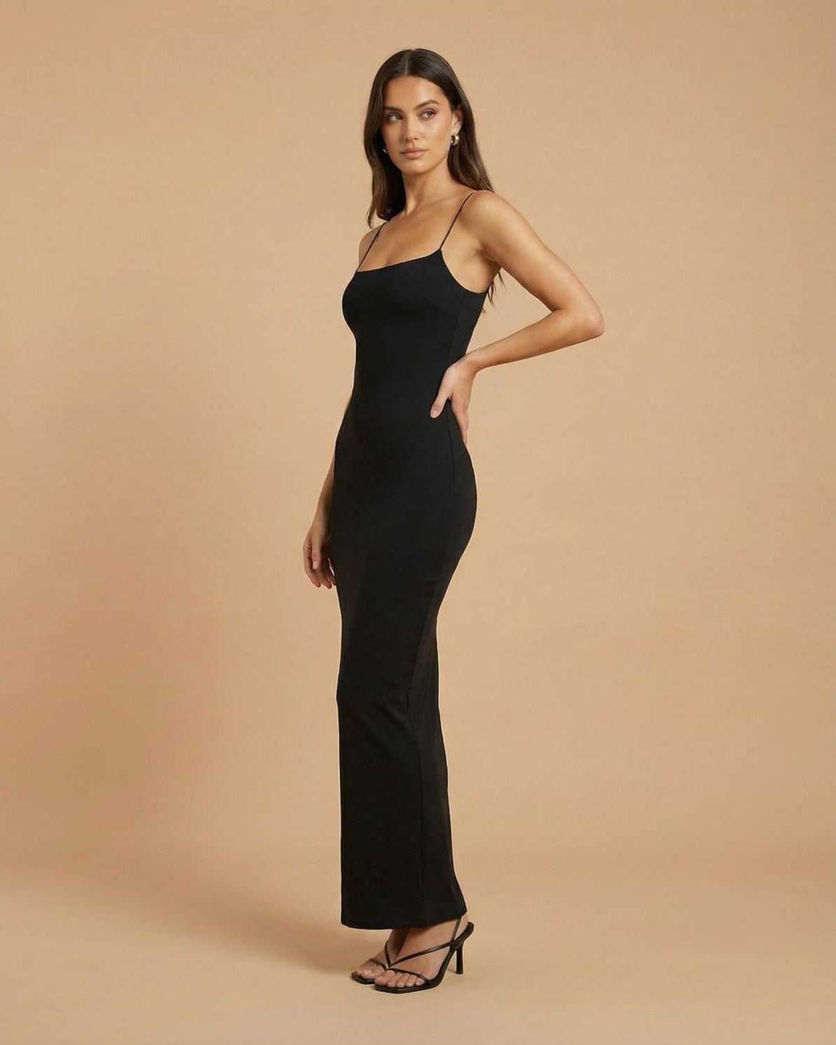 Calypso Maxi Dress by Lauven featuring a minimal black design and backless silhouette.