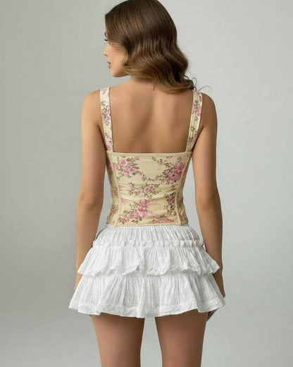 Back view of a woman wearing the Camellia Corset Top by Lauven, featuring floral design and structured silhouette.
