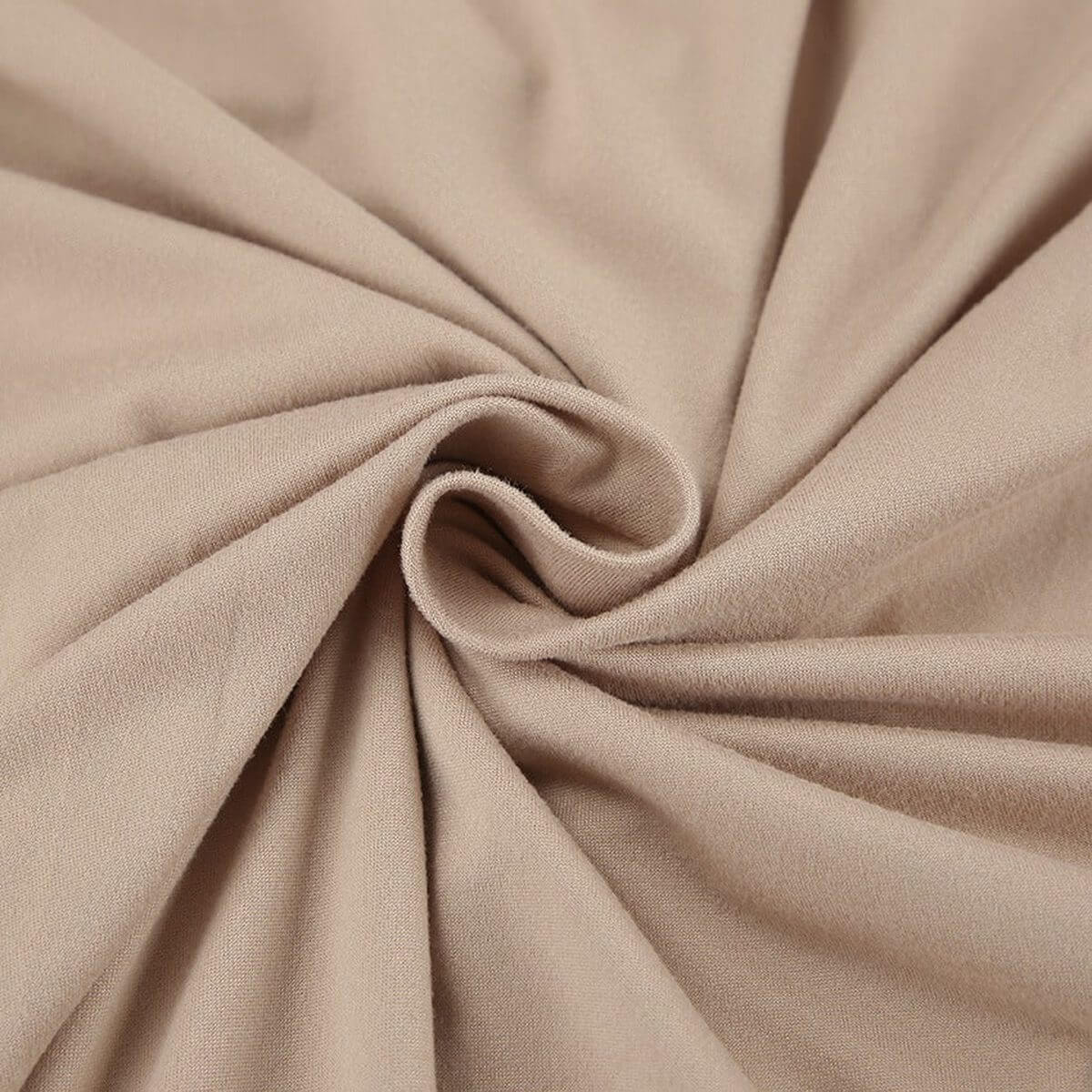 Close-up of soft cappuccino-toned fabric, showcasing the smooth texture for the Sculpted Grace Maxi Dress.