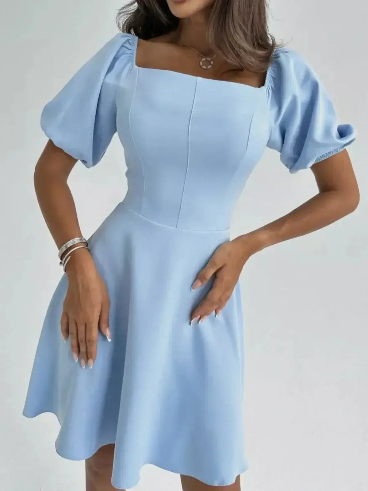 Celeste Charm Mini Dress in light blue with puff sleeves and flared skirt, perfect for summer events and weddings.