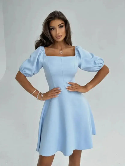 Light blue Celeste Charm Mini Dress featuring puff sleeves, fitted waist, and flared skirt, perfect for summer events.
