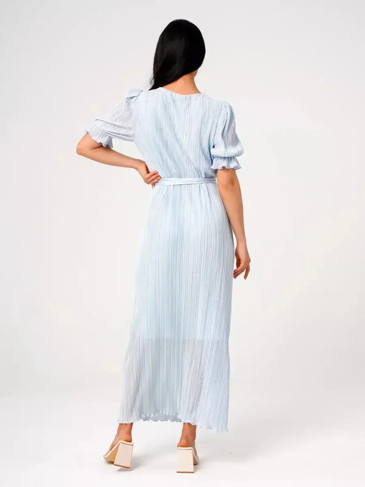 Back view of the light blue Celeste Flow Maxi Dress featuring pleated fabric and a self-tie waist, ideal for summer occasions.