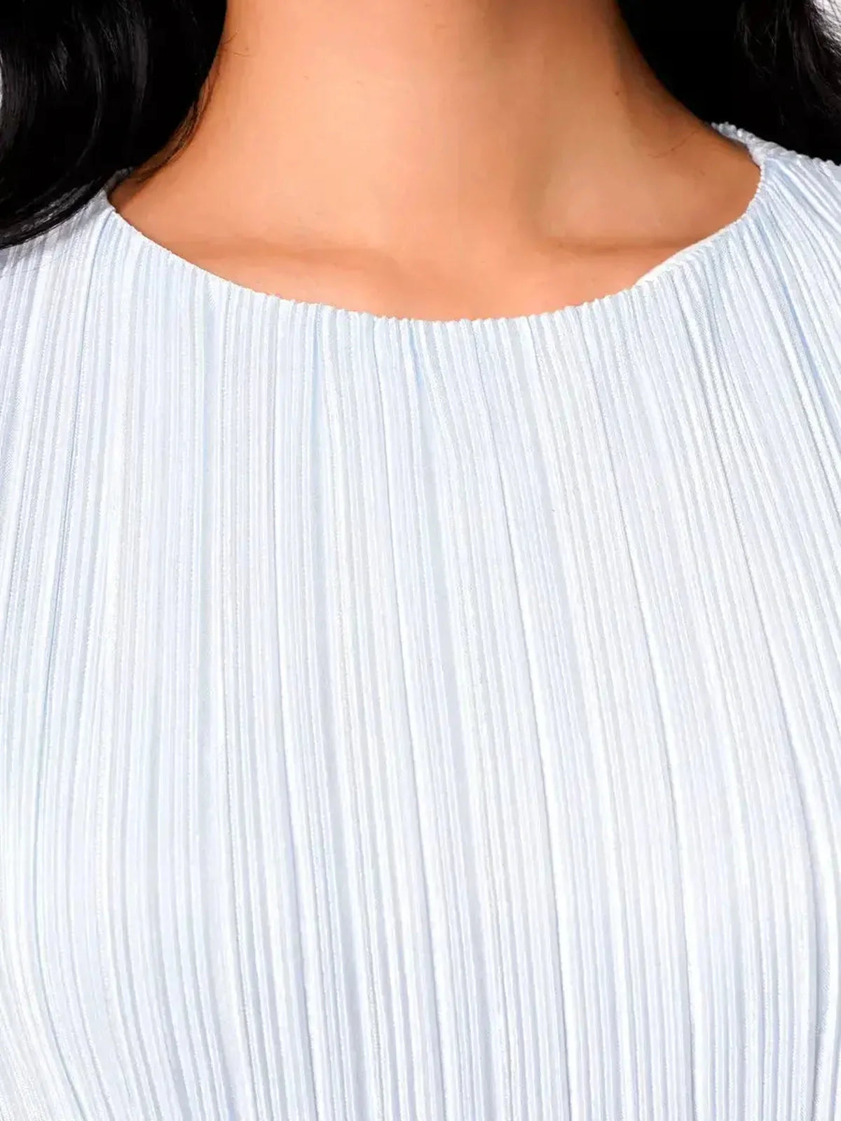 Close-up of light blue pleated fabric from the Celeste Flow Maxi Dress, showcasing elegant texture and design.