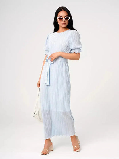 Celeste Flow Maxi Dress in light blue, featuring pleats, puff sleeves, and self-tie waistbelt, ideal for summer occasions.