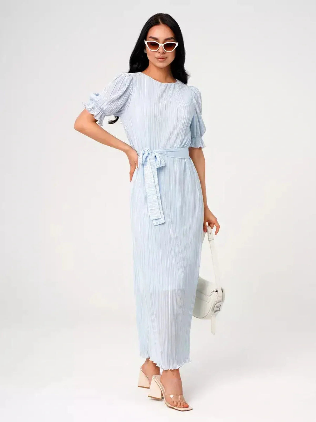 Celeste Flow Maxi Dress in light blue with pleats and waist tie, perfect for summer weddings or formal events.