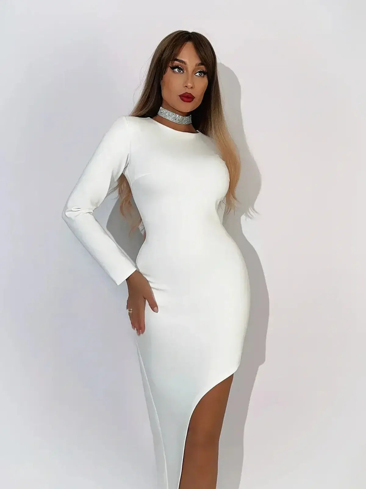 Model showcasing the Celeste Maxi Dress in creamy-white, featuring a sophisticated silhouette and asymmetric hemline.