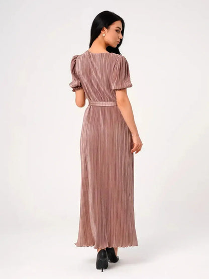 Back view of the Celeste Maxi Dress featuring elegant pleats and puff sleeves in light cappuccino hue.