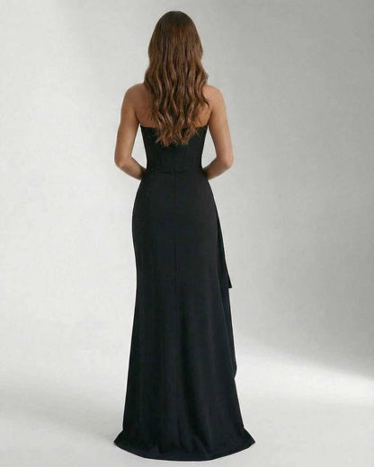 Back view of the Celeste Maxi Dress by Lauven, featuring a sleek and elegant strapless design and thigh-high slit.