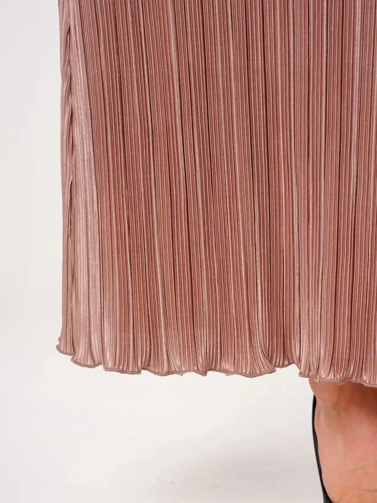 Pleated hem detail of the light cappuccino Celeste Maxi Dress, showcasing its elegant texture and fluid drape.