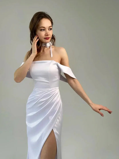Model showcases Celeste Maxi Dress—off-shoulder with a thigh-high slit and sculpted sleeves, exuding elegance.