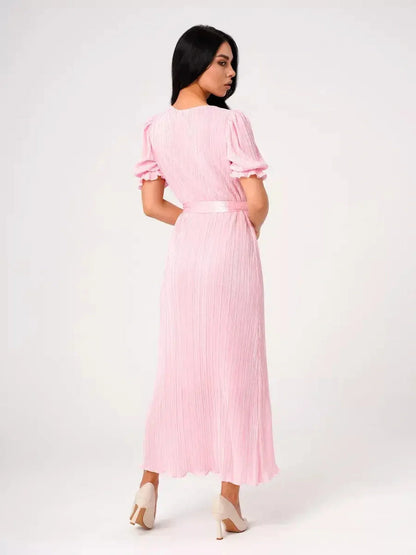Back view of a pink pleated Celeste maxi dress featuring puff sleeves and a tie waist, perfect for formal occasions.