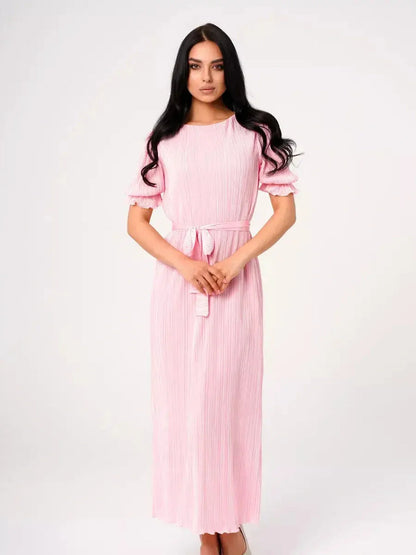 Celeste Maxi Dress in pink, featuring pleated fabric, puff sleeves, and a tie waist for elegant summer style.