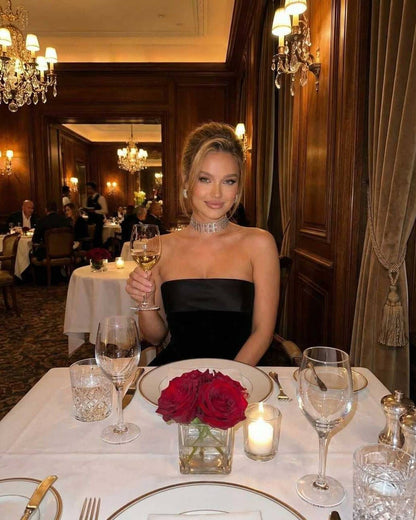 Celeste Mini Dress worn in an elegant setting, featuring a strapless velvet design and sophisticated style, by Lauven.
