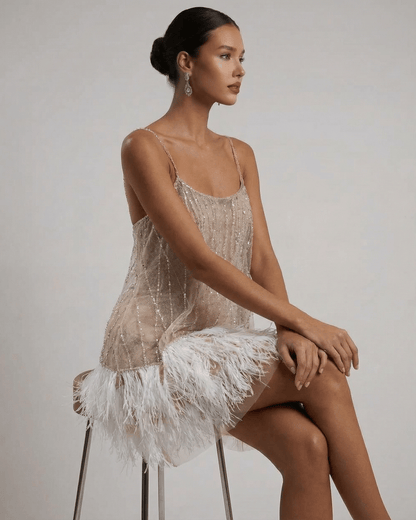 Celeste Mini Dress by Lauven, showcasing a sequin tulle design with a feather tassel hem, embodying fairycore elegance.