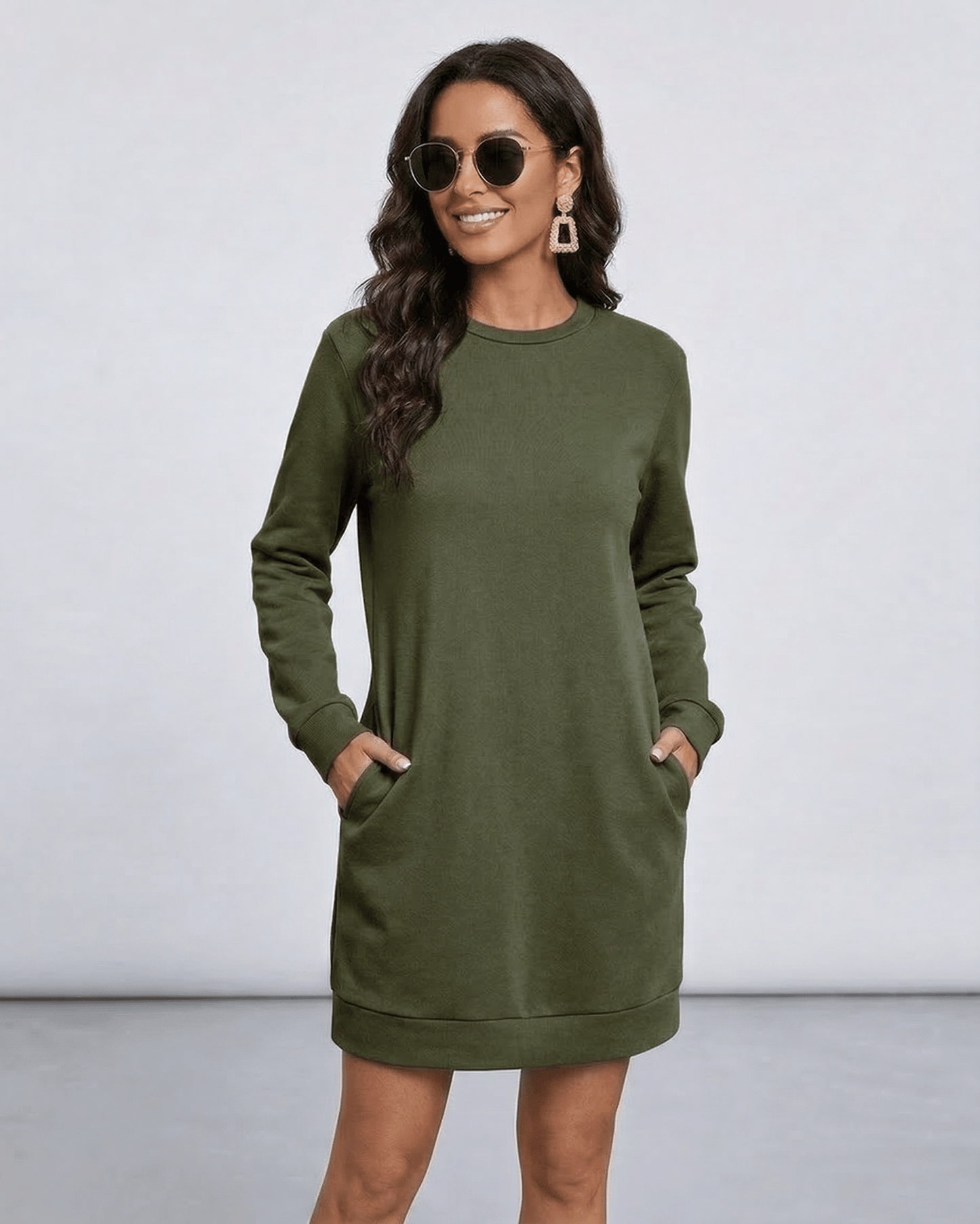 Model wearing Celeste Mini Dress by Lauven in olive green with pockets, showcasing casual style.