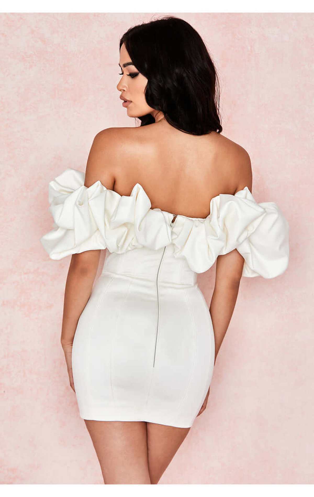 Back view of a women’s off-shoulder white mini dress with ruffles, perfect for weddings or evening events.