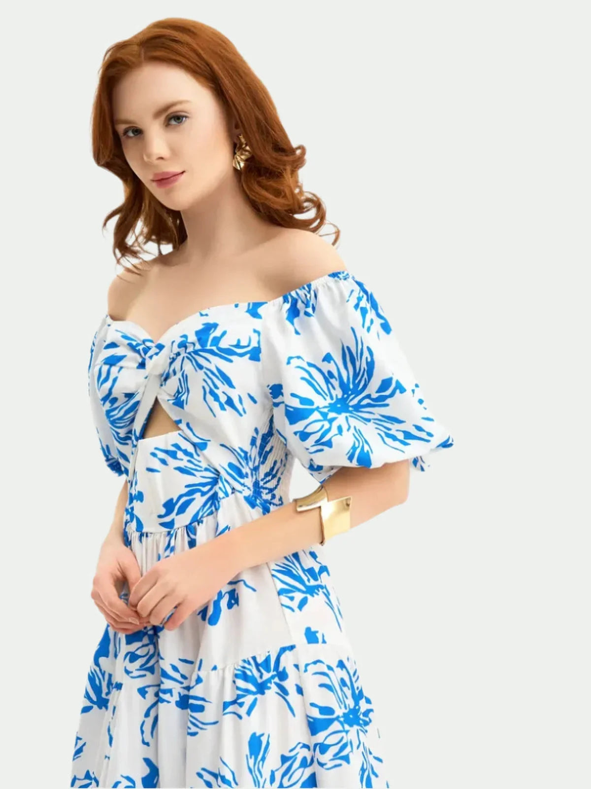 Model wearing Celestial Petals Maxi Dress, white with cornflower blue floral print, showcasing sweetheart neckline and puff sleeves.