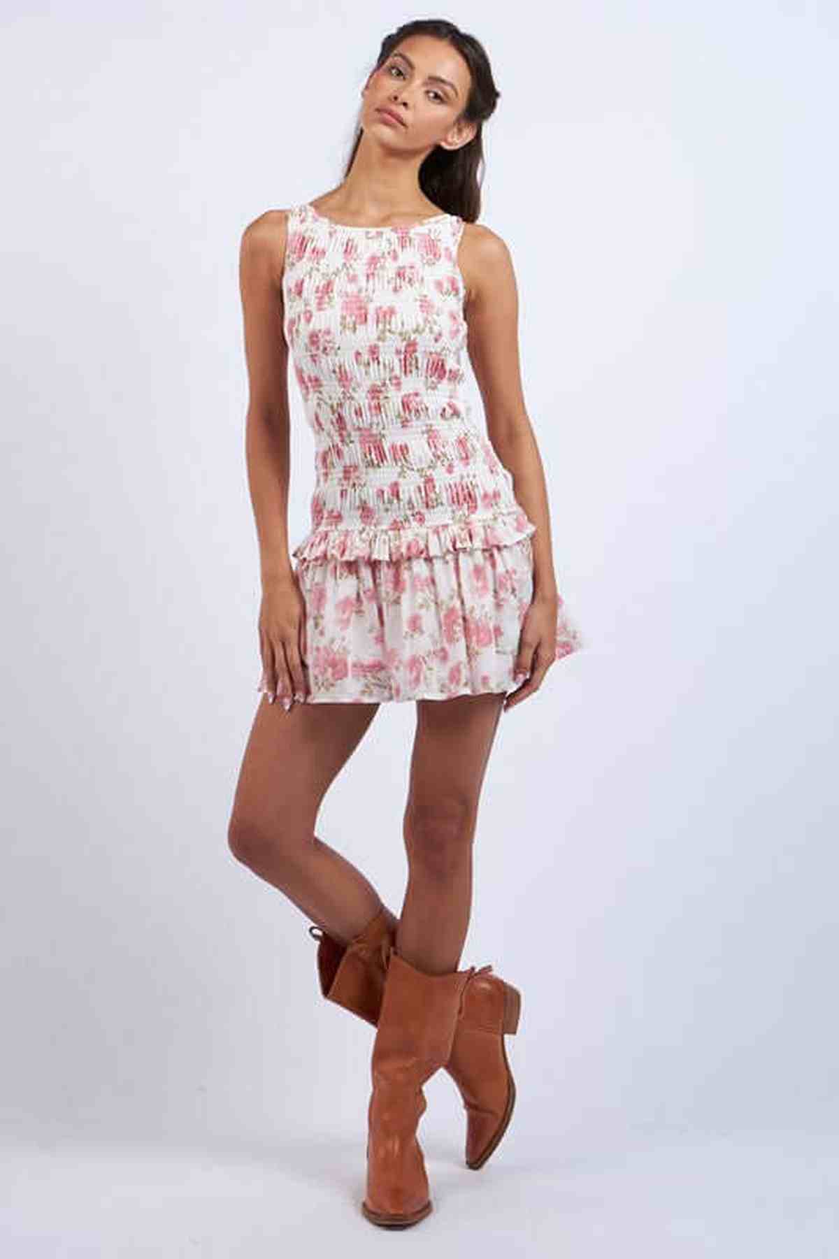 Model wearing a floral Chloe Mini Dress with a flared hem and cowboy boots, perfect for summer or casual outings.