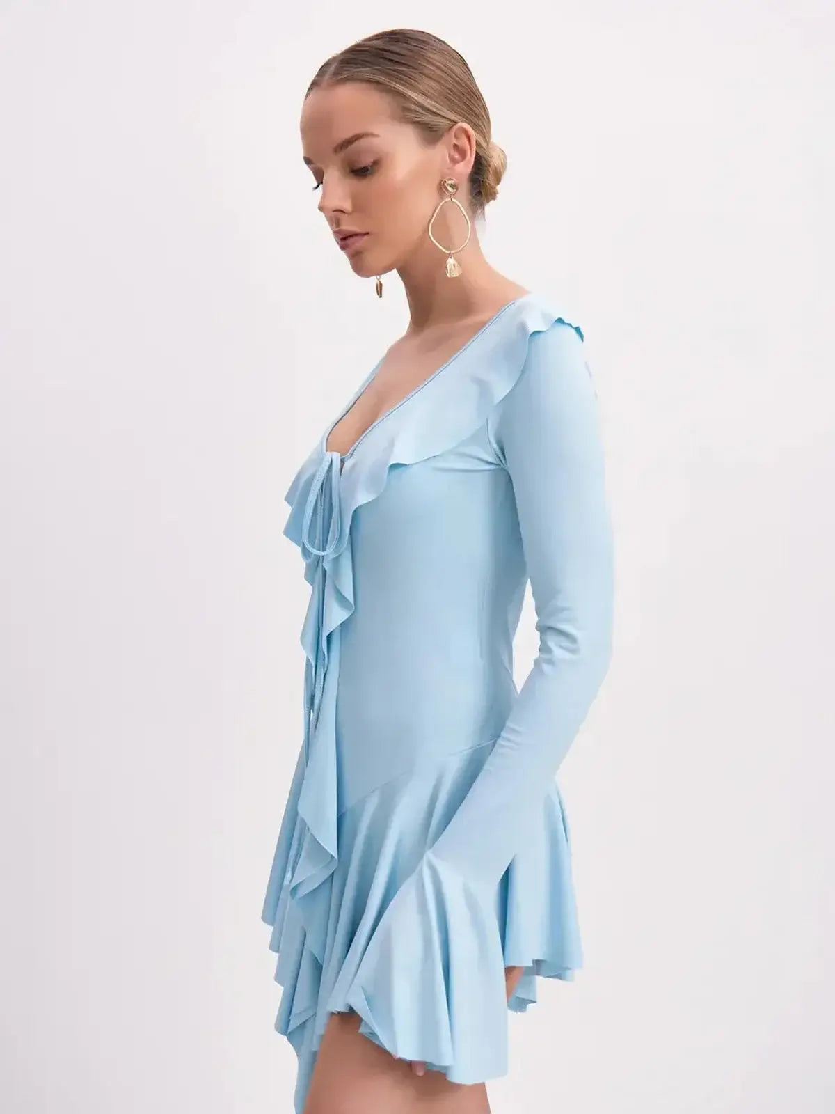 Sky-blue long sleeve Cloud Ruffle mini dress with a flattering V-neckline and cascading ruffle trim.