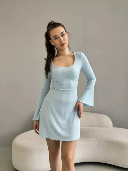 Model wearing a light blue Cloudline Charm mini dress with long bell sleeves, perfect for summer and weddings.
