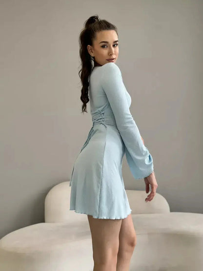 Model showcasing the dreamy Cloudline Charm mini dress in soft blue, perfect for summer parties and weddings.