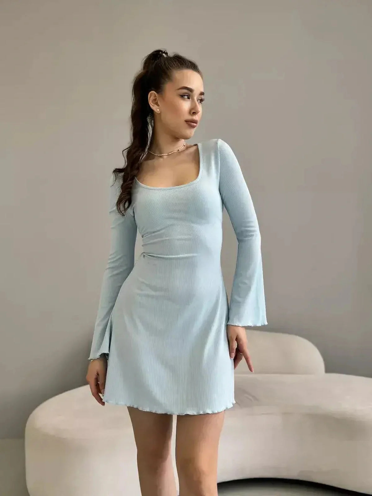 Elegant mini dress in soft ribbed cotton blend, featuring long bell sleeves and a flattering silhouette, perfect for summer.
