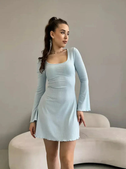 Elegant mini dress in soft ribbed cotton blend, featuring long bell sleeves and a flattering silhouette, perfect for summer.