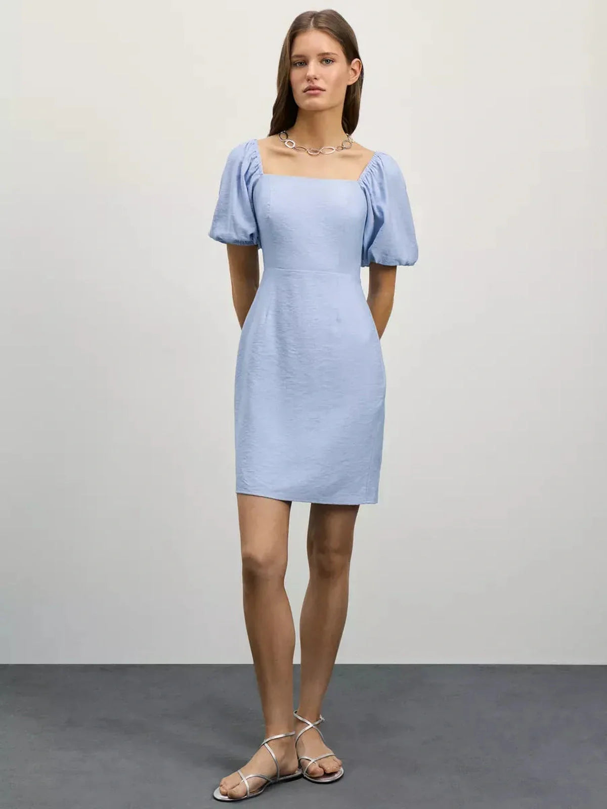 Light blue Cloudline Mini summer dress with square neckline and puff sleeves, perfect for warm-weather occasions.