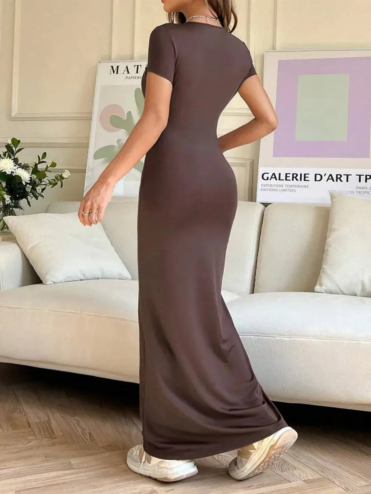 Cocoa Curve Maxi Dress in brown with back slit and asymmetric neckline, showcasing sleek fit and elegant styling.