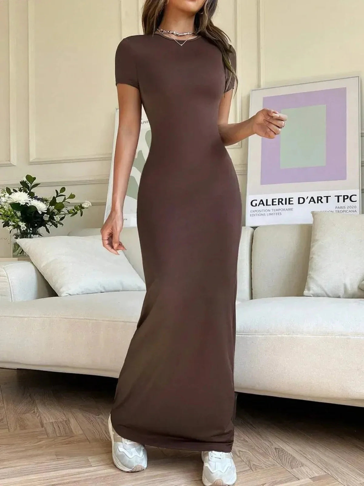 Cocoa Curve Maxi Dress showcasing sleek fit with back slit and asymmetric neckline, styled for elegance and comfort.