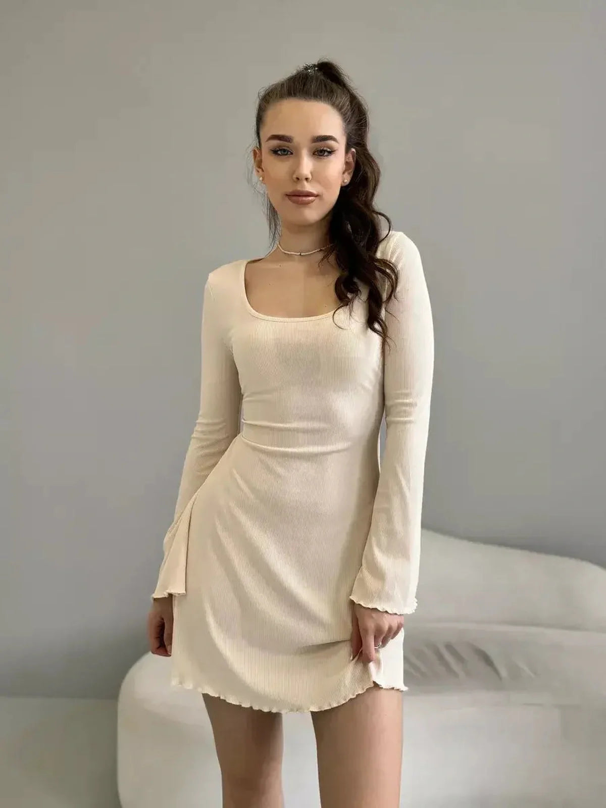 Effortlessly elegant Cream Belle mini dress featuring a romantic square neckline and long sleeves.