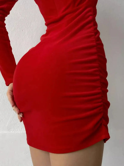 Red bodycon mini dress featuring ruched side seams and long sleeves, perfect for evening wear and special occasions.