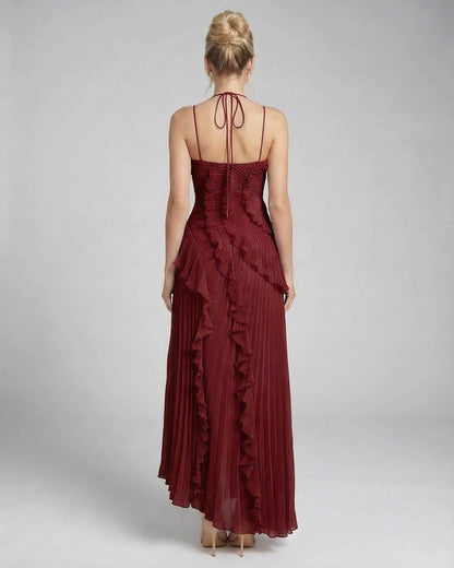 Back view of a model wearing the Lauven Crimson Maxi Dress, showcasing its pleated chiffon and ruffle details.