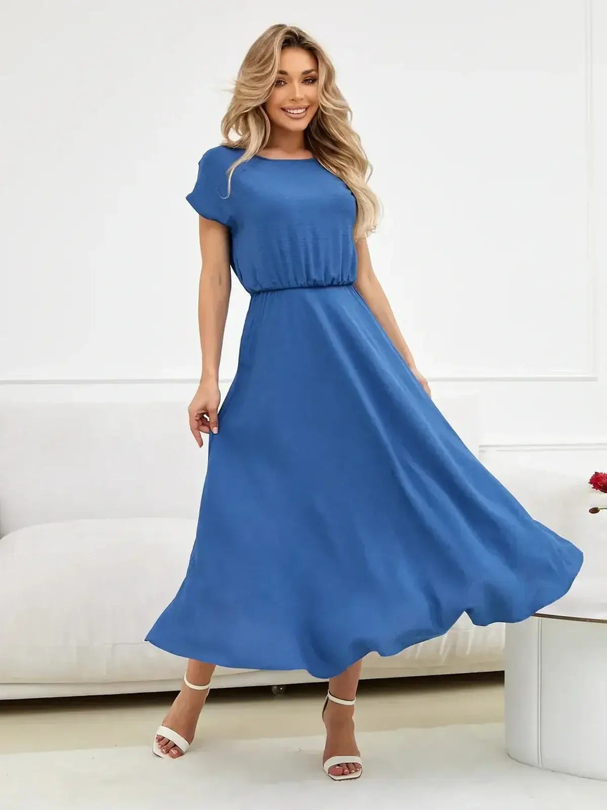 Model wearing a blue Drift Maxi Dress, showcasing relaxed elegance and flowy design for summer occasions.