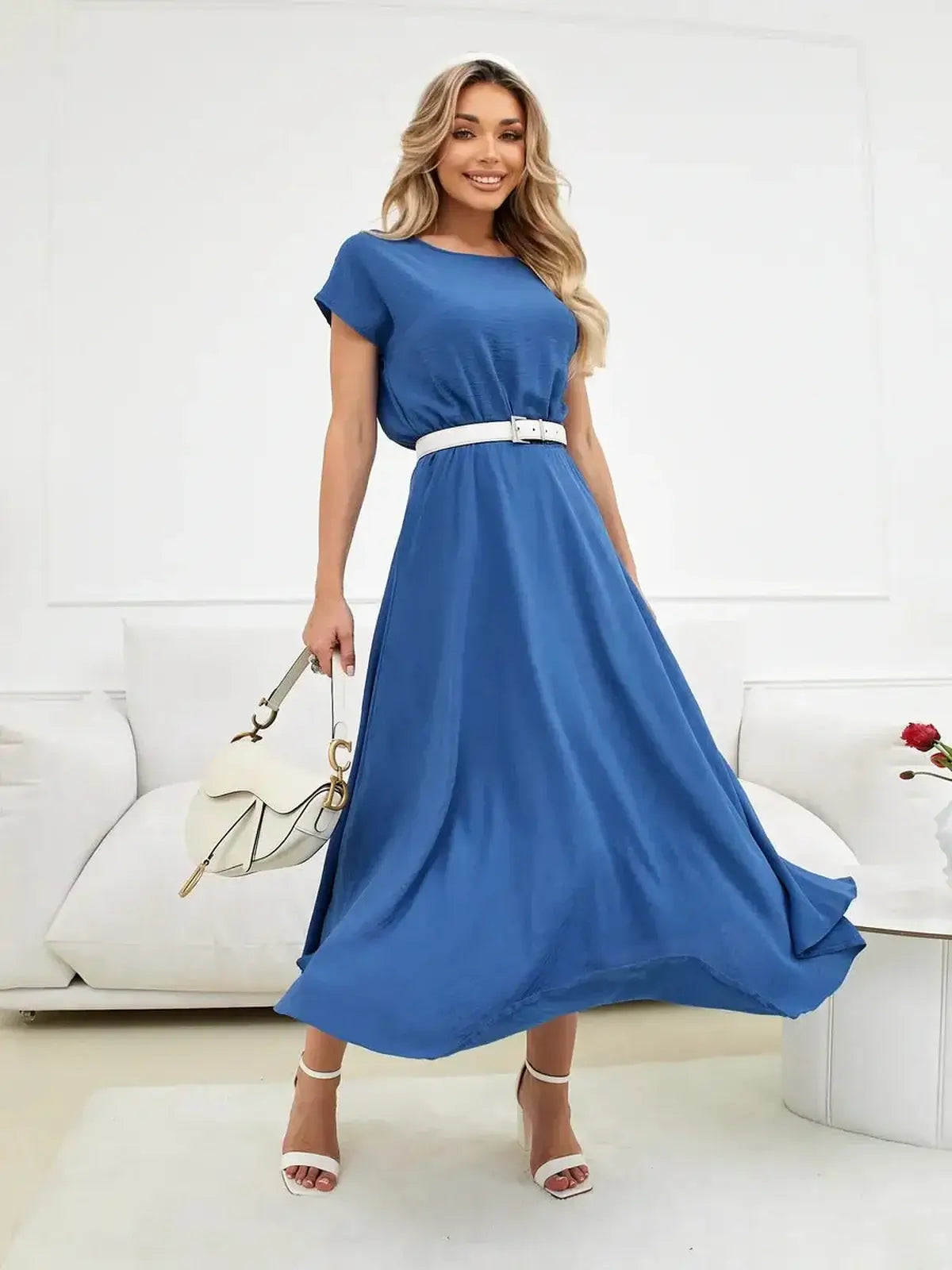Model wearing a blue Drift Maxi Dress with a white belt, showcasing its flowy design and relaxed fit.