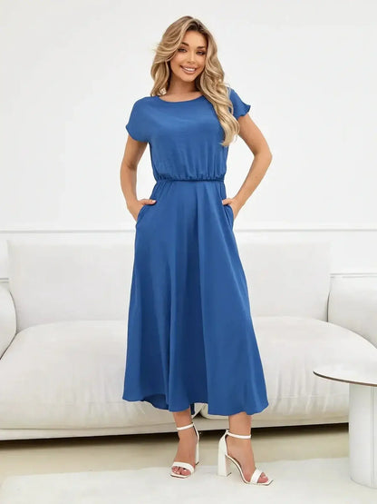 Model wearing a blue Drift Maxi Dress with pockets, showcasing lightweight elegance and a relaxed fit.