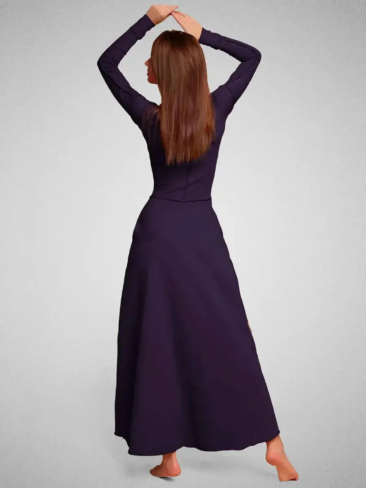 Back view of a woman wearing the dark violet Eclipse Maxi Dress, showcasing its elegant silhouette and long sleeves.