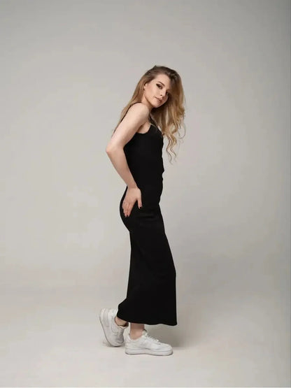 Eclipse Maxi Dress on model, showcasing minimalist elegance with a sleeveless design and stylish white sneakers.