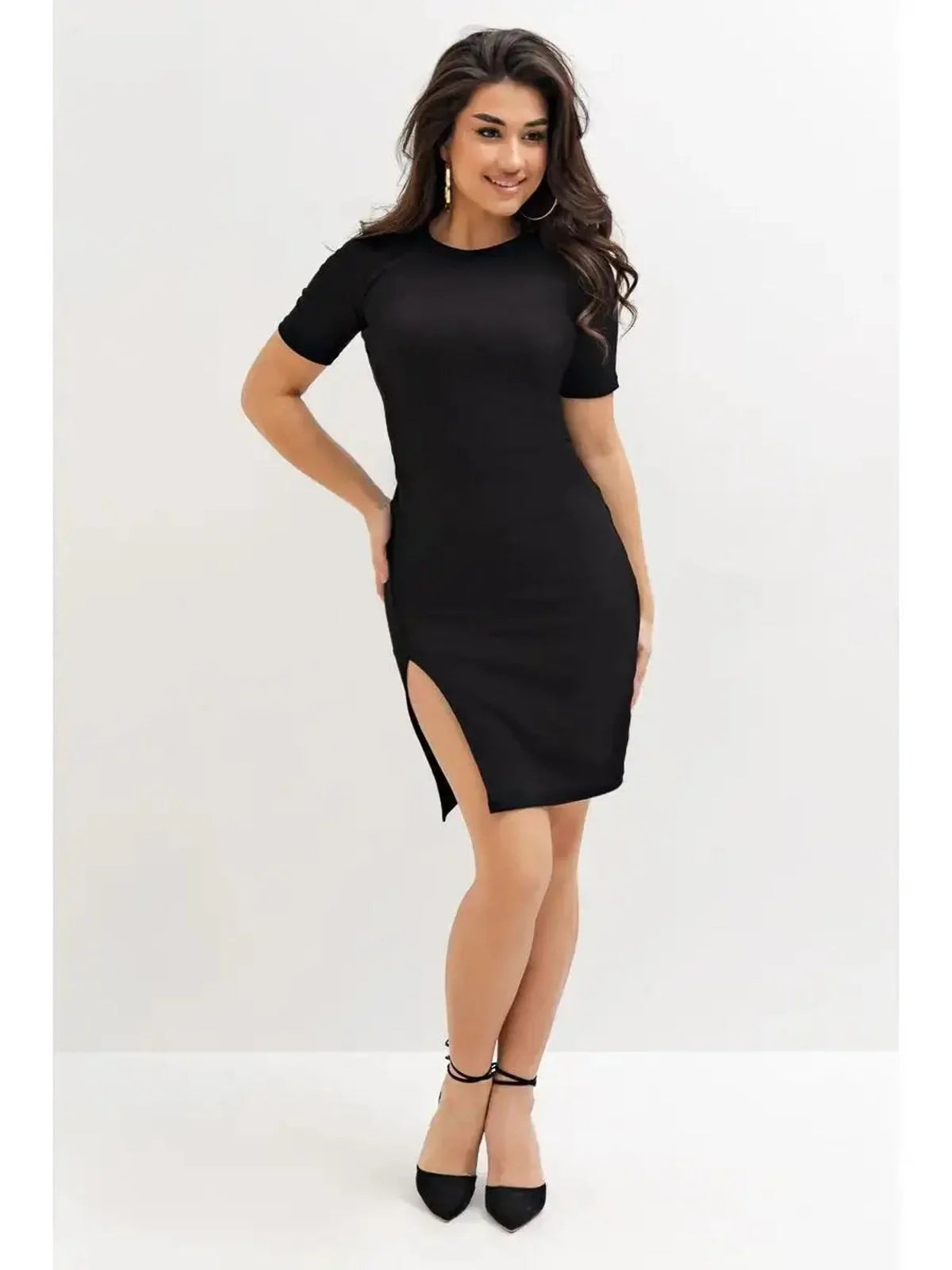 Model wearing the Edge Affair black mini dress featuring a figure-hugging design and high side slit.