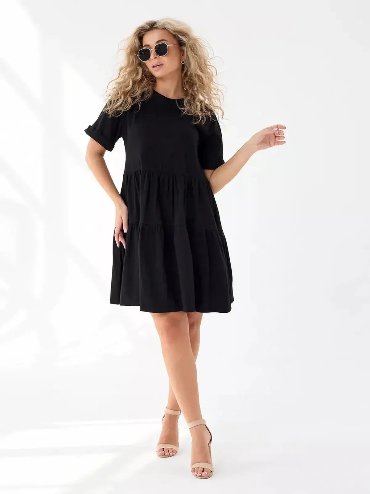 Oversized black mini dress with tiered silhouette, perfect for summer and casual outings.